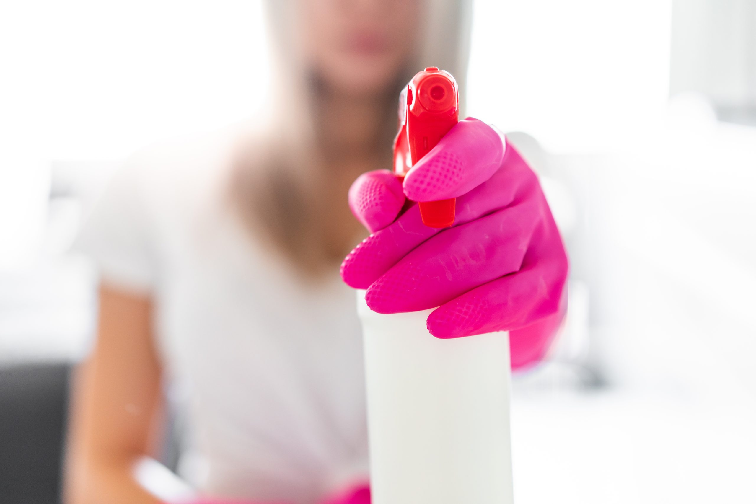 Cleaner holding a spray bottle in Newtownards